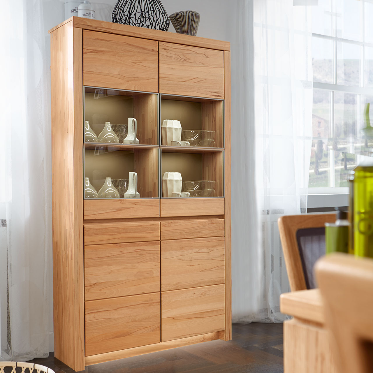 Soleo-3000-Zeilenschrank-5940-ambiente-Kernbuche SOLEO 3000 Zeilenschrank Type 5940 in massiver Kernbuche, mit zwei unteren Holztüren und zwei oberen Türen mit vier Vitrienenfächer. Hinter den Türen sind 3 Holzböden und 1 Glasboden inklusive, als Ambiente Bild.