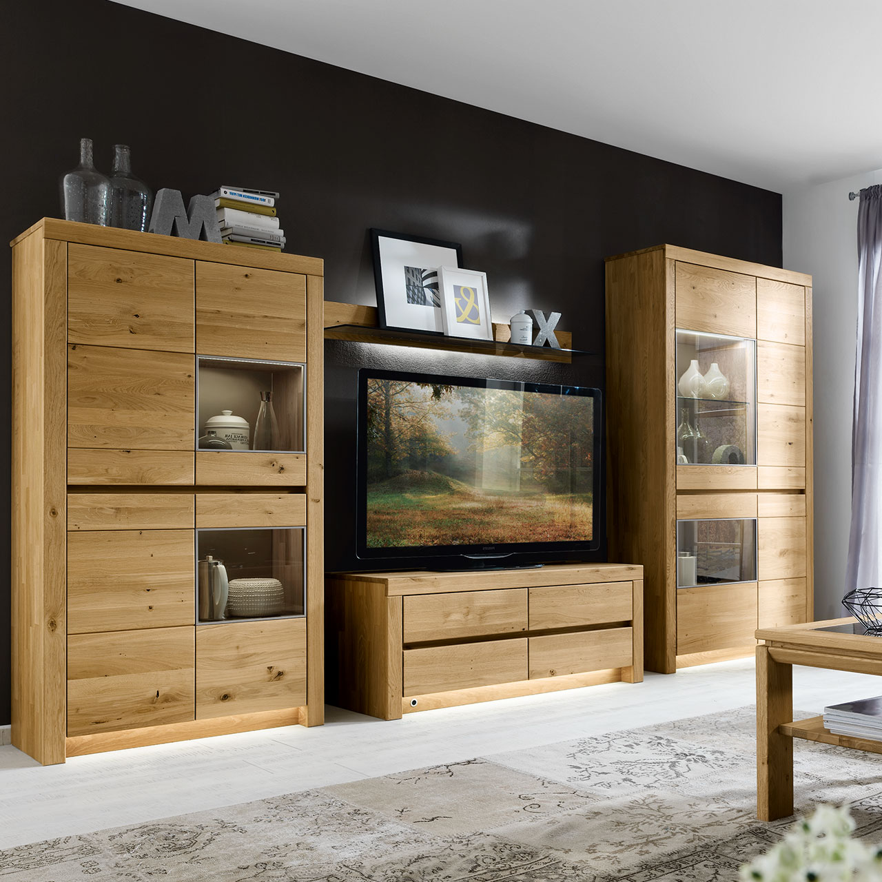 Soleo-3000-Medienschrank-1355-ambiente-wildeiche Medienschrank in massiver Wildeiche Type 1355 mit vier Schubkästen oder optional mit 3 Schubkästen und einer Klappe. In einer modernen Wohnwand gezeigt.