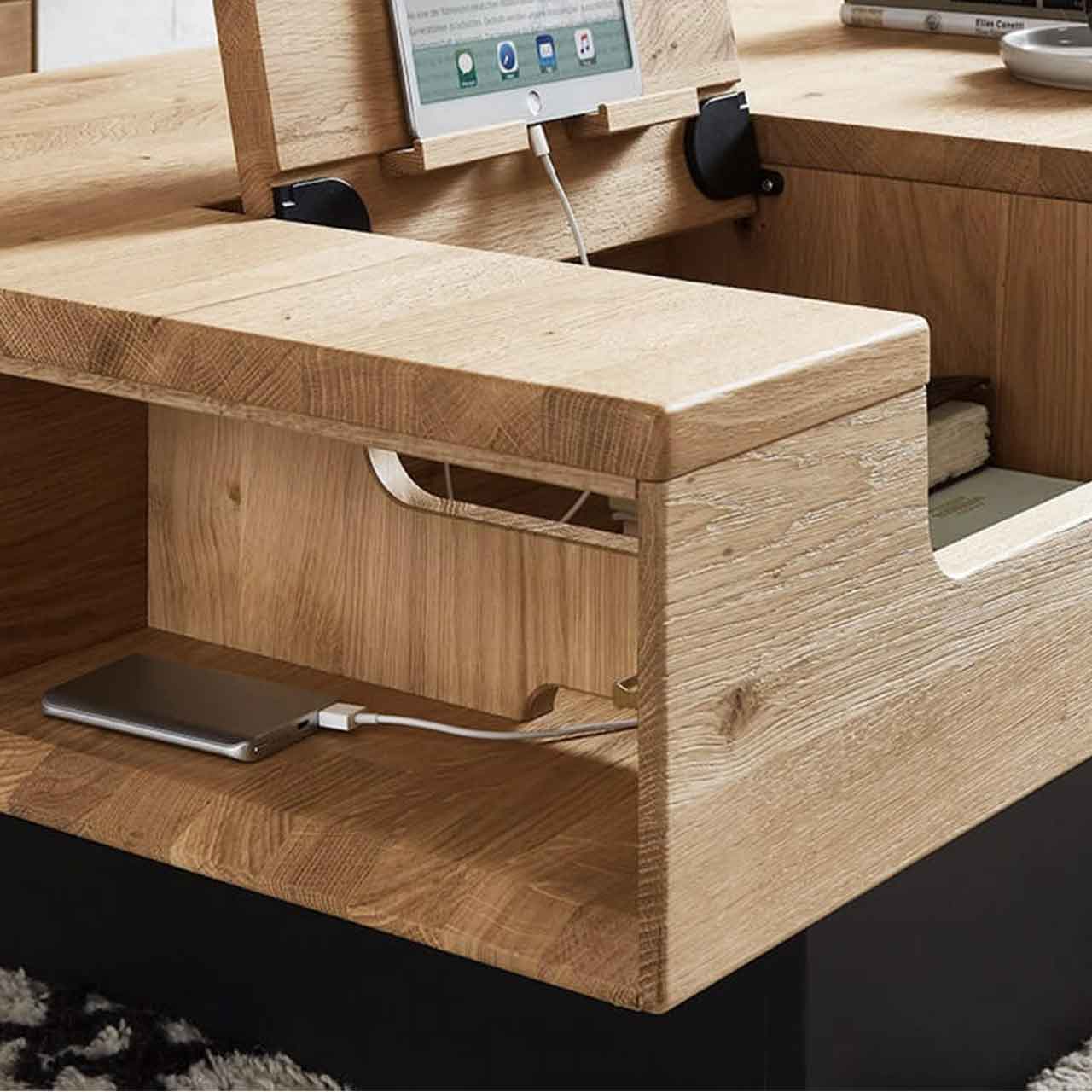 WM 2250 - Säulencouchtisch WM 2250 - Säulencouchtisch, Säule in Schwarz und als Tisch in rechteckiger Form in Wildeiche, mit extravaganten Highlights, wie eine Medienklappe, versteckter Schublade. Nahaufnahme der versteckten Strom Anschlüsse.